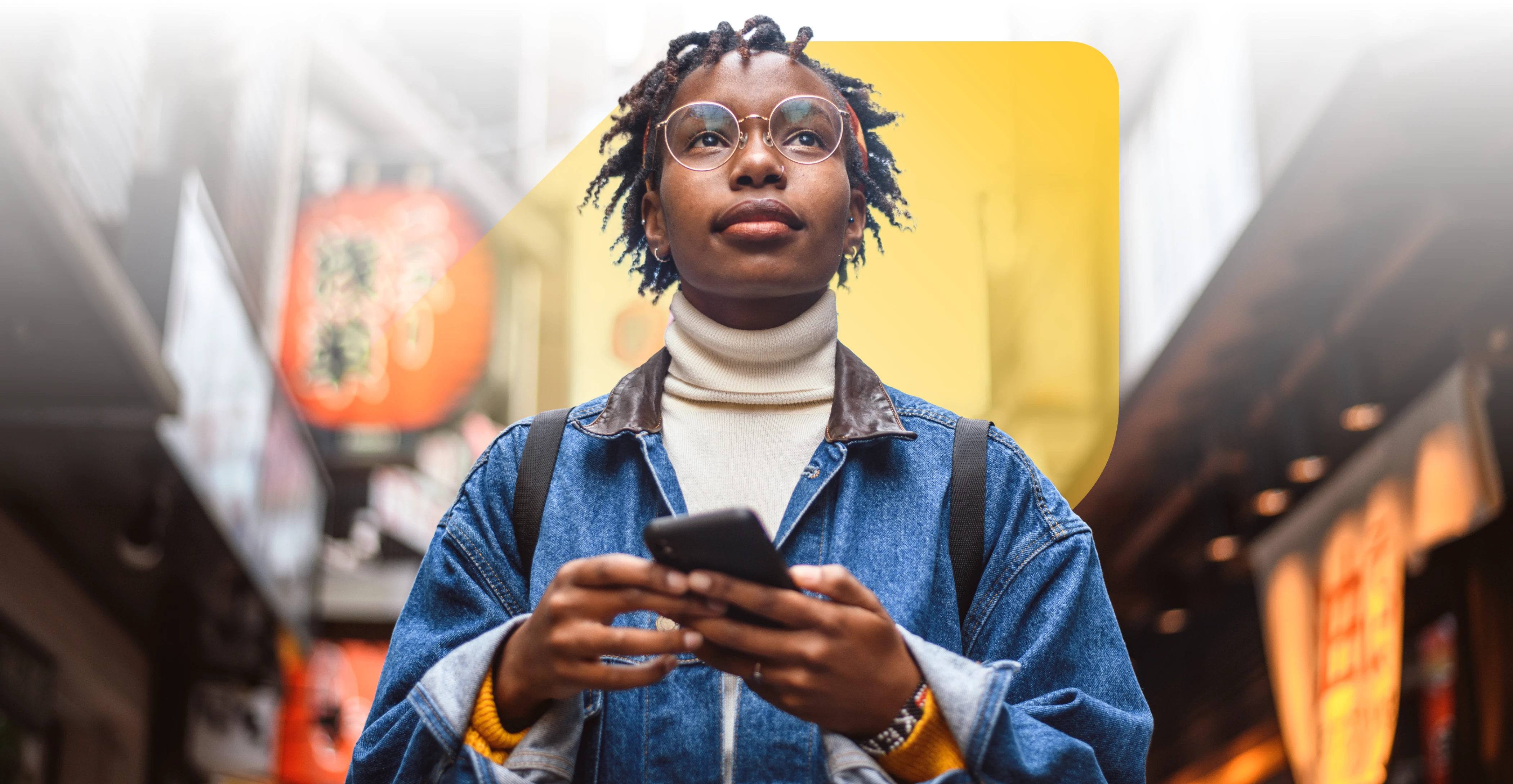 Woman looking upward with phone in hand, with EQ Bank jewel symbol set against city backdrop.